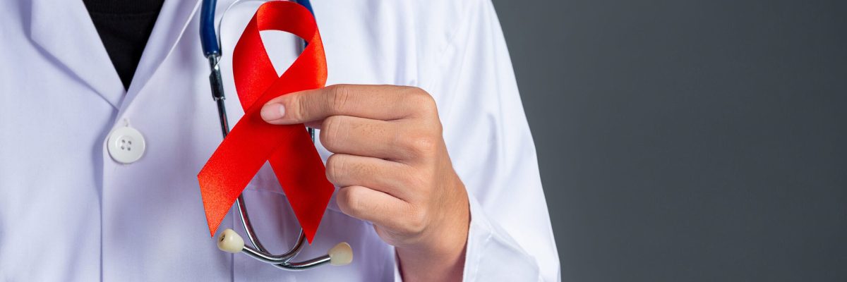 The doctor holds a red ribbon, HIV awareness awareness, World AIDS Day and World Sexual Health Day.