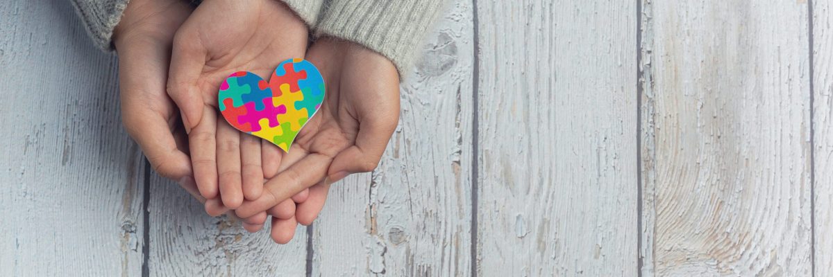 Closeup on two young lovers holding hands at a table.
