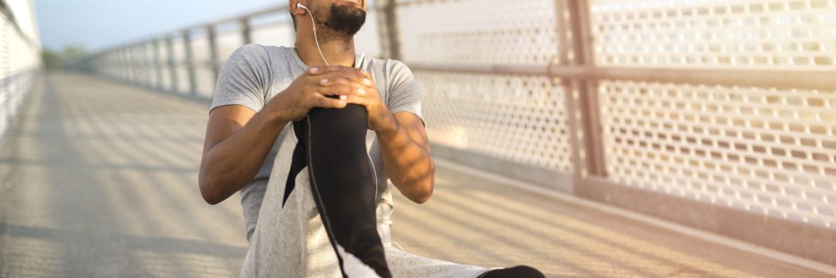 Sportsman having knee injury problem during running training.