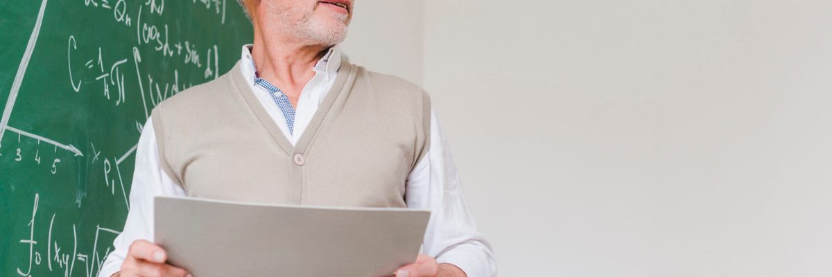 frowning-aged-math-teacher-with-paper-sheets