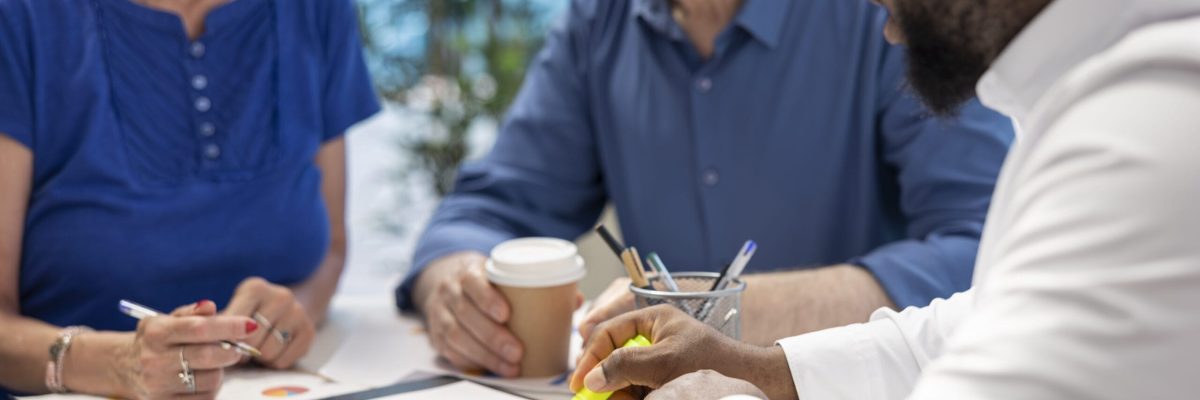 Insurance broker highlighting the important contract terms, discussing with senior couple about a new retirement plan to secure pension and finances in the future. Advisory counseling.